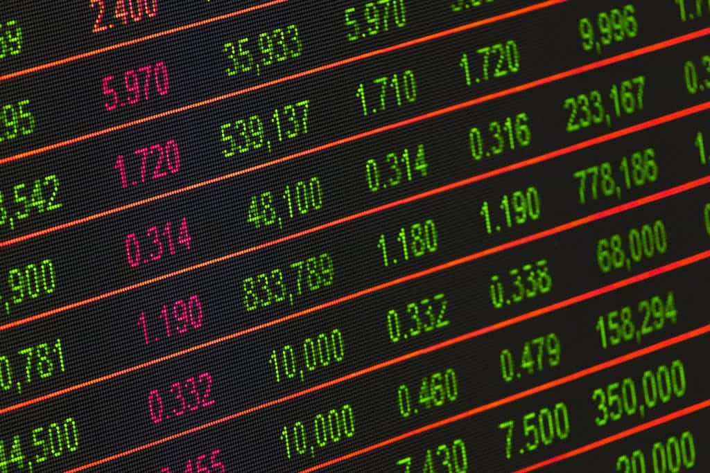 Close-up of a digital stock market data display showing colorful financial numbers and trends.