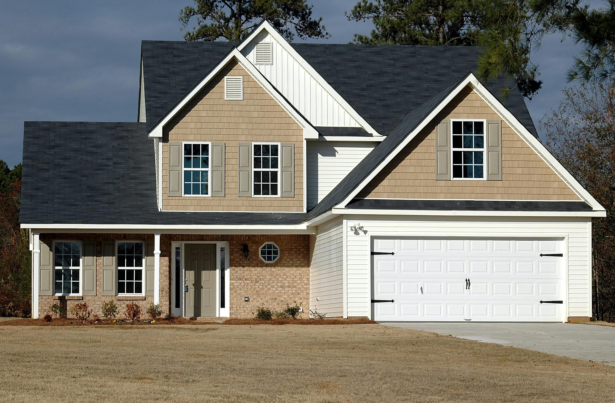 Elegant two-storey house with garage, showcasing modern architecture and residential charm.